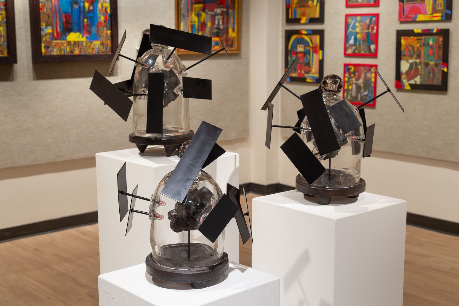 Charles Wells sculpture: paired works with glass forms behind angled black plates
