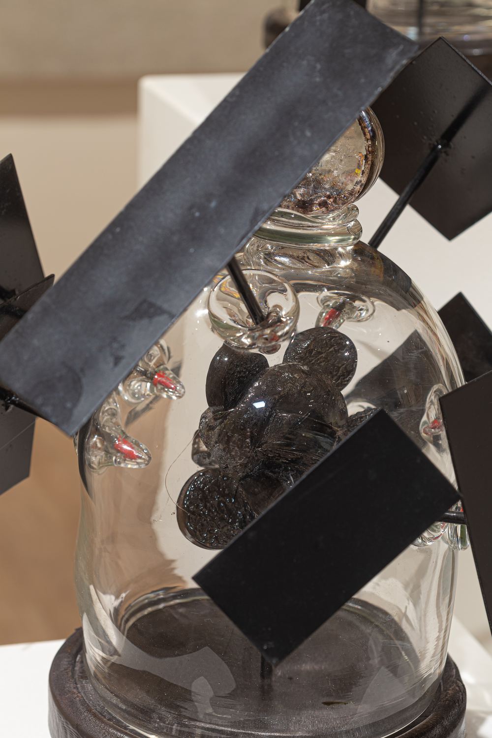 Charles Wells sculpture detail: a metal plate crossing the glass form it conceals