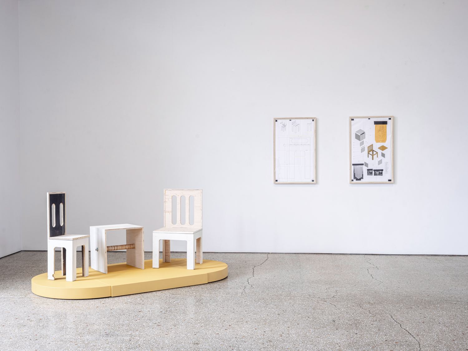 Justin Hodges: Gallery Furniture on its platform with the two framed exploded-view prints behind